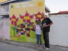 Posing in front of mural.